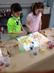 Fourth graders painting duets as they build upon the idea of collaboration