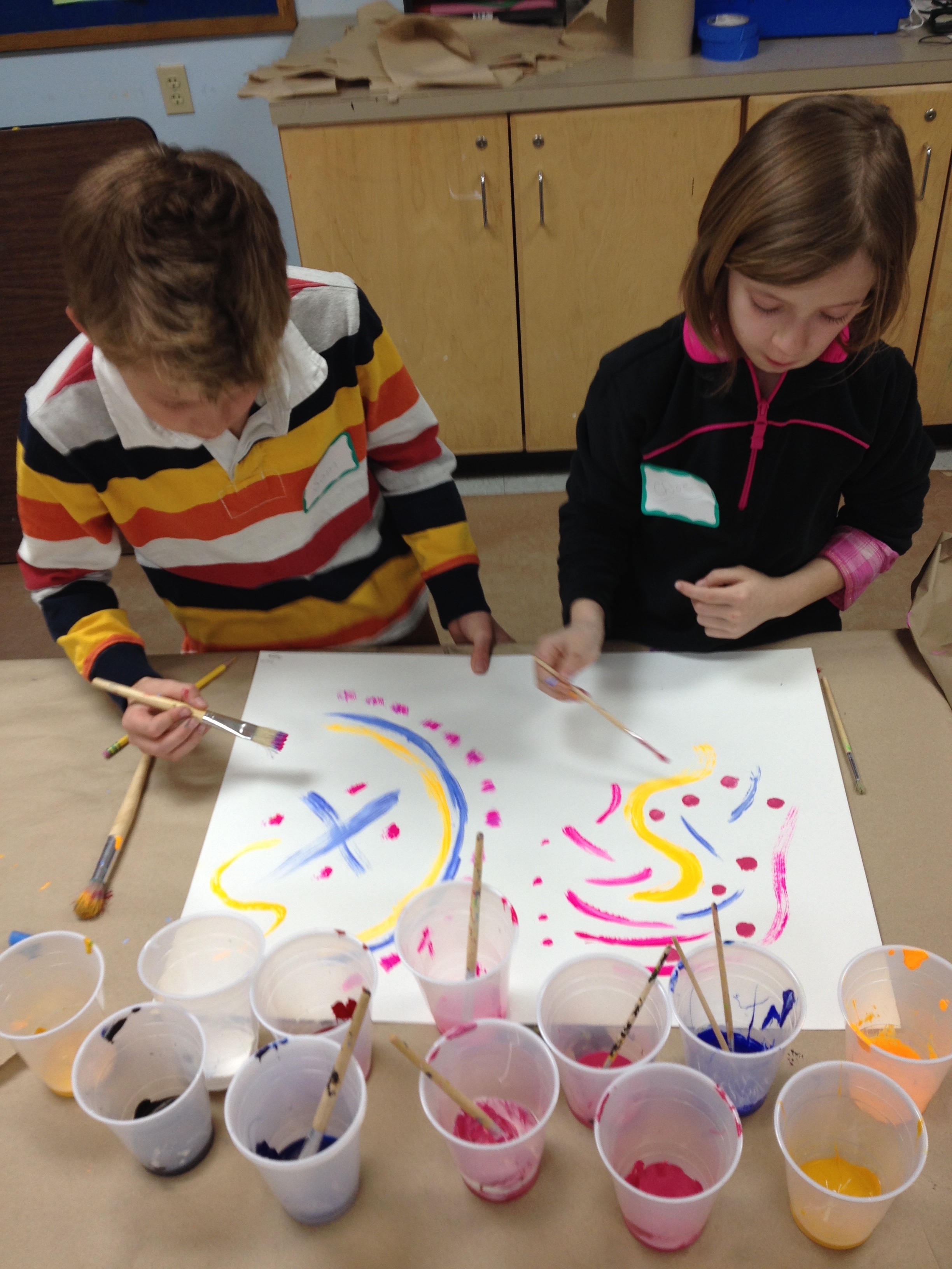 Two Applewild fourth grade students begin collaborating for the first time while Ears 'n' Eyes personnel converse with them while jamming on the blues