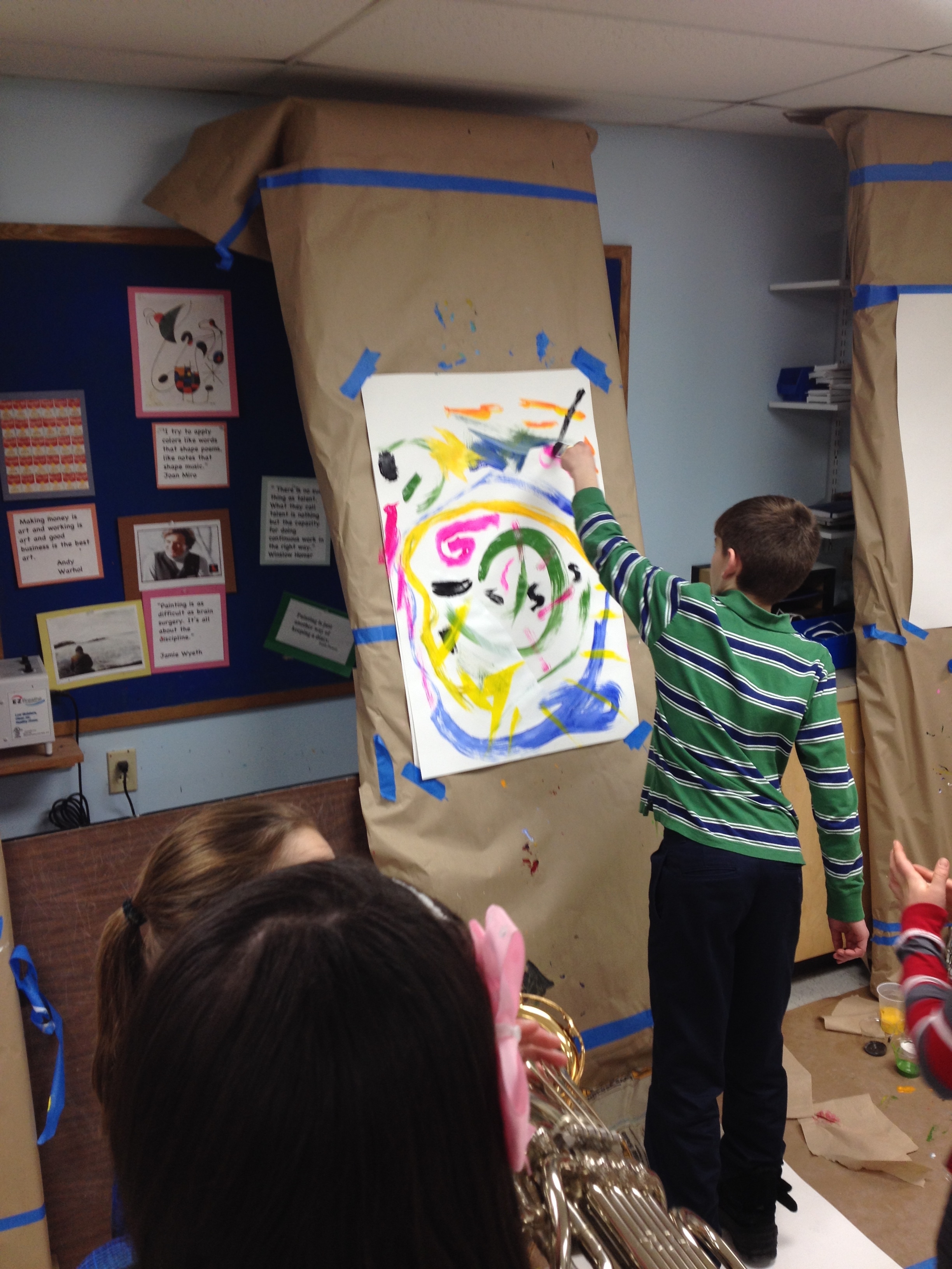 Trumpet, blurred in the foreground, 'talks' to the young painter at the easel