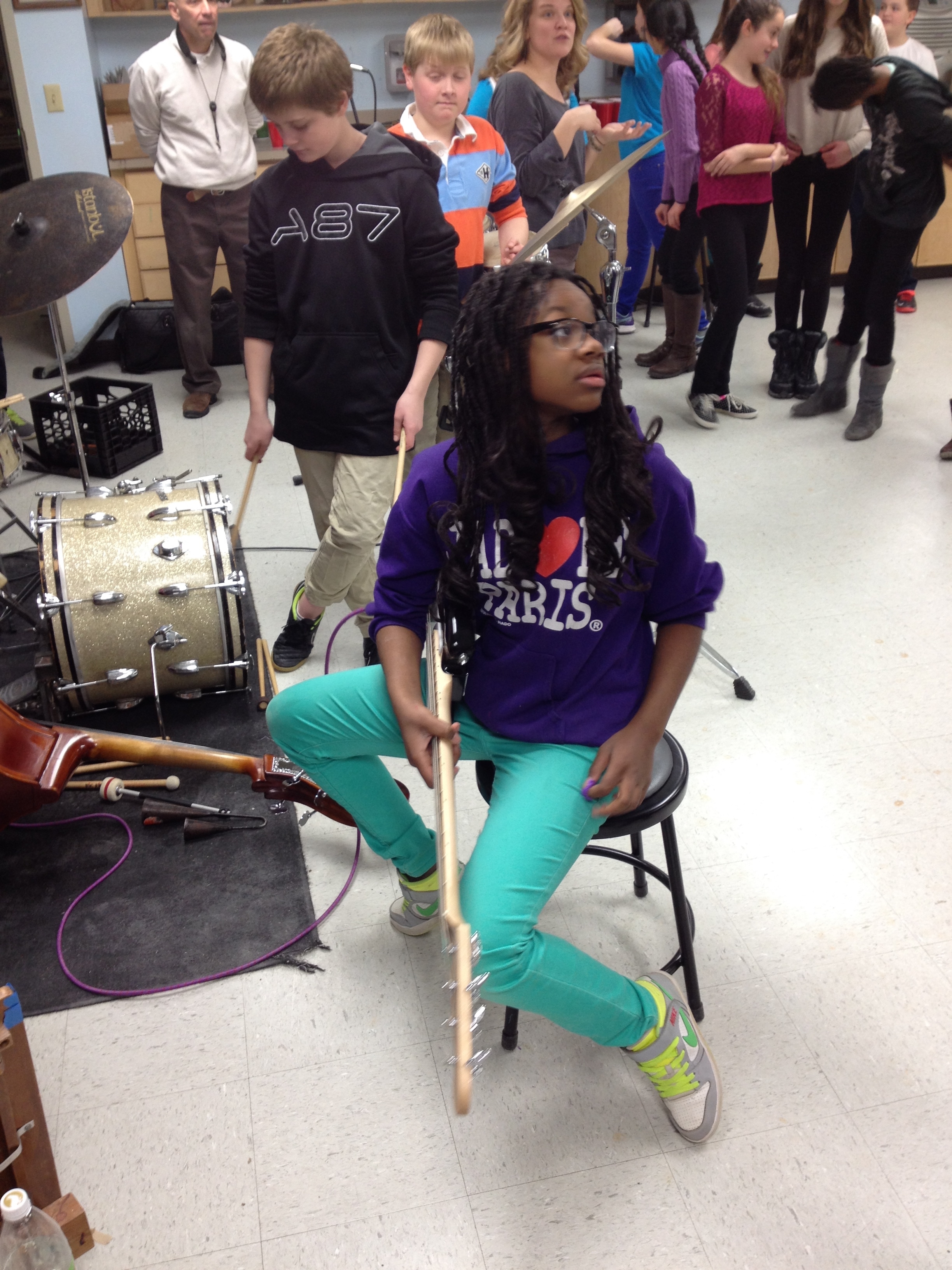 Young bassist listens intently as we compose a song to be performed in music and paint