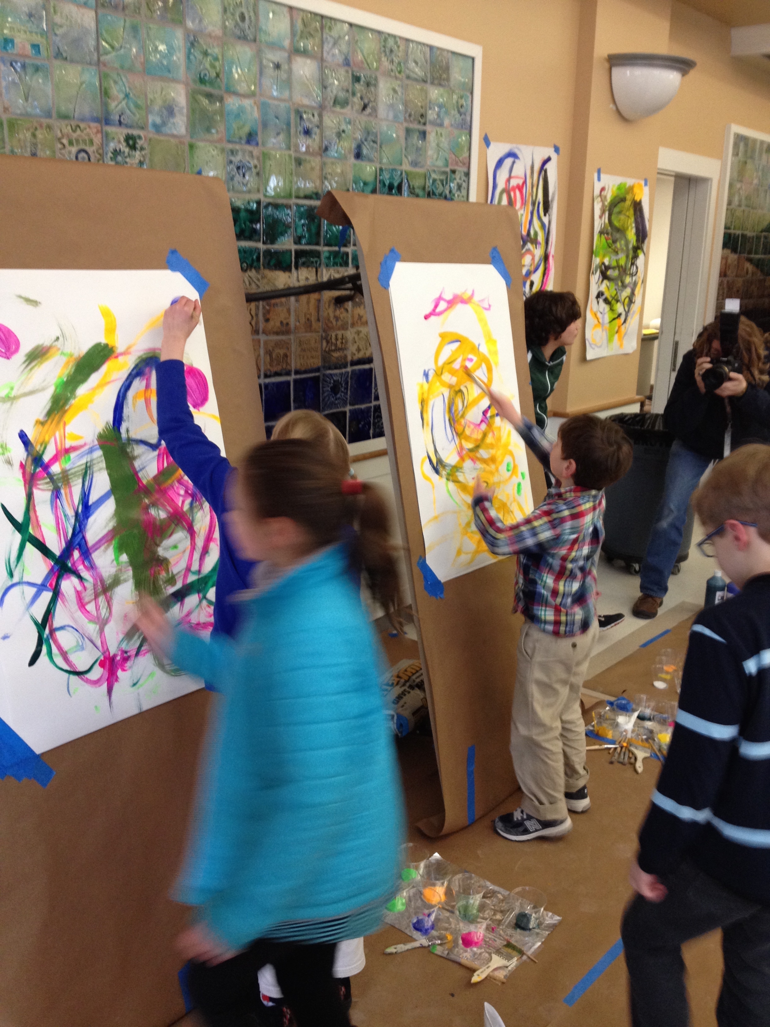 Young painters put their talents to work at the Harlem Renaissance Block party celebration. Amanda, seen in the background captures the event on film.